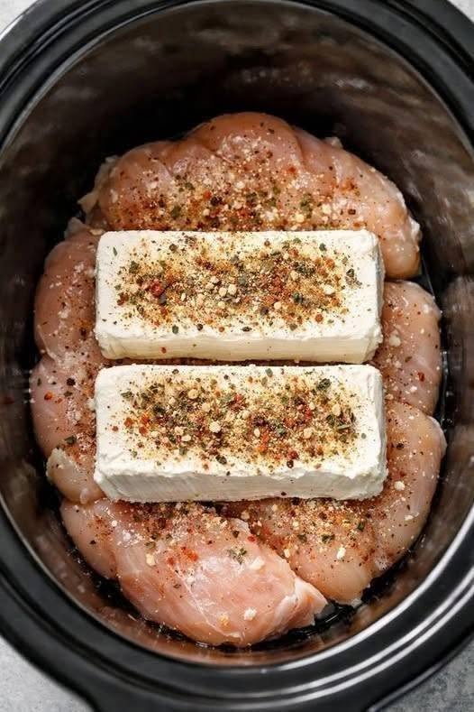 Put raw chicken breasts in the crock pot, top with blocks of cream cheese